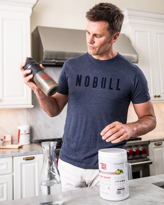 Tom Brady in NOBULL Shirt holding a bottle